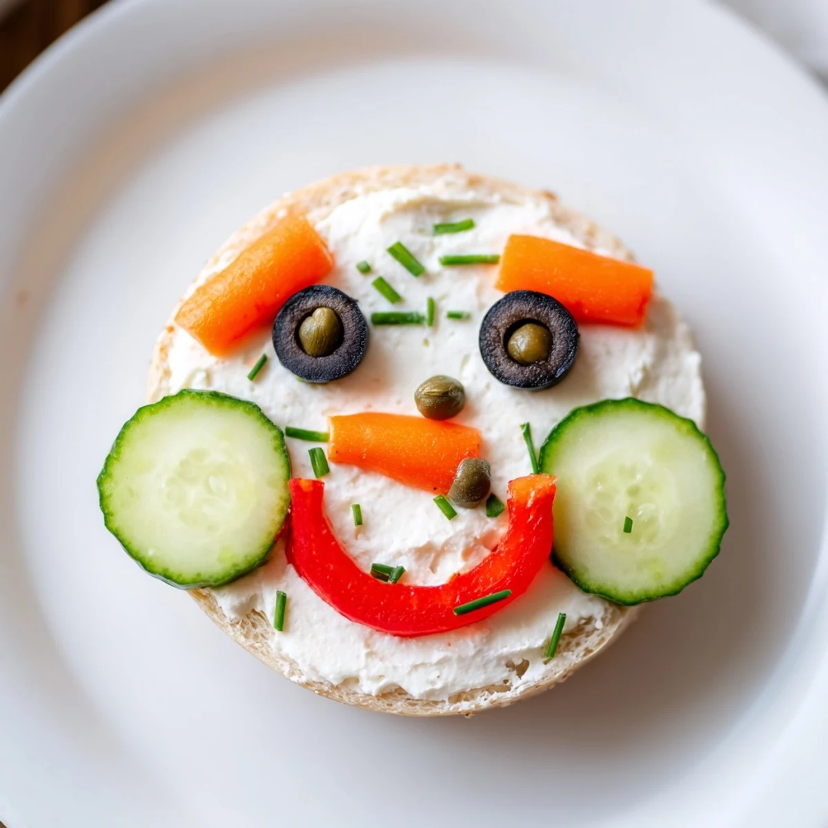 Festive snowman mini bagel sandwiches, a close-up shows the cream cheese and colorful veggie faces.
