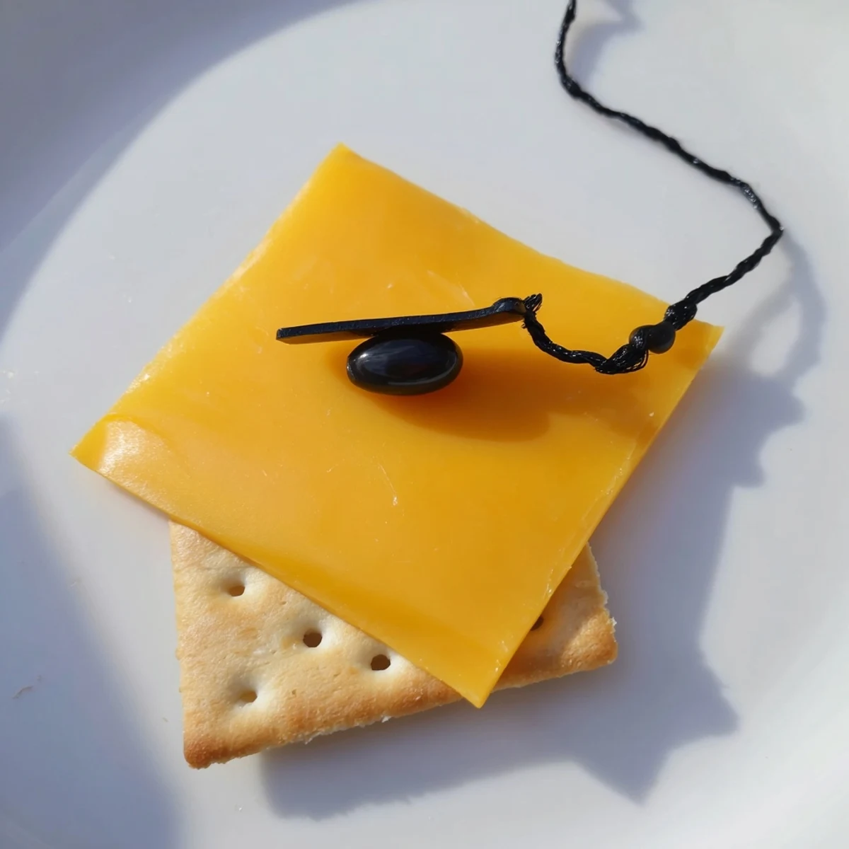 Festive Graduation Cap Snacks on a platter, showcasing cheese 'caps' and licorice tassels, ready to enjoy.
