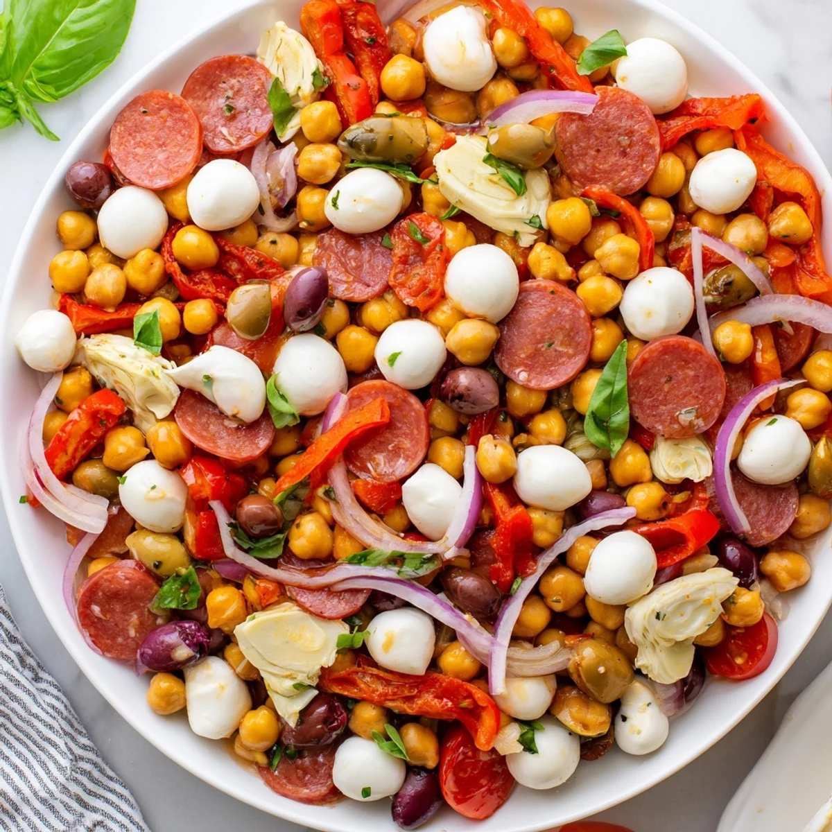 Hearty Antipasto Chickpea Salad, bursting with fresh tomatoes, olives, and a zesty Italian dressing.