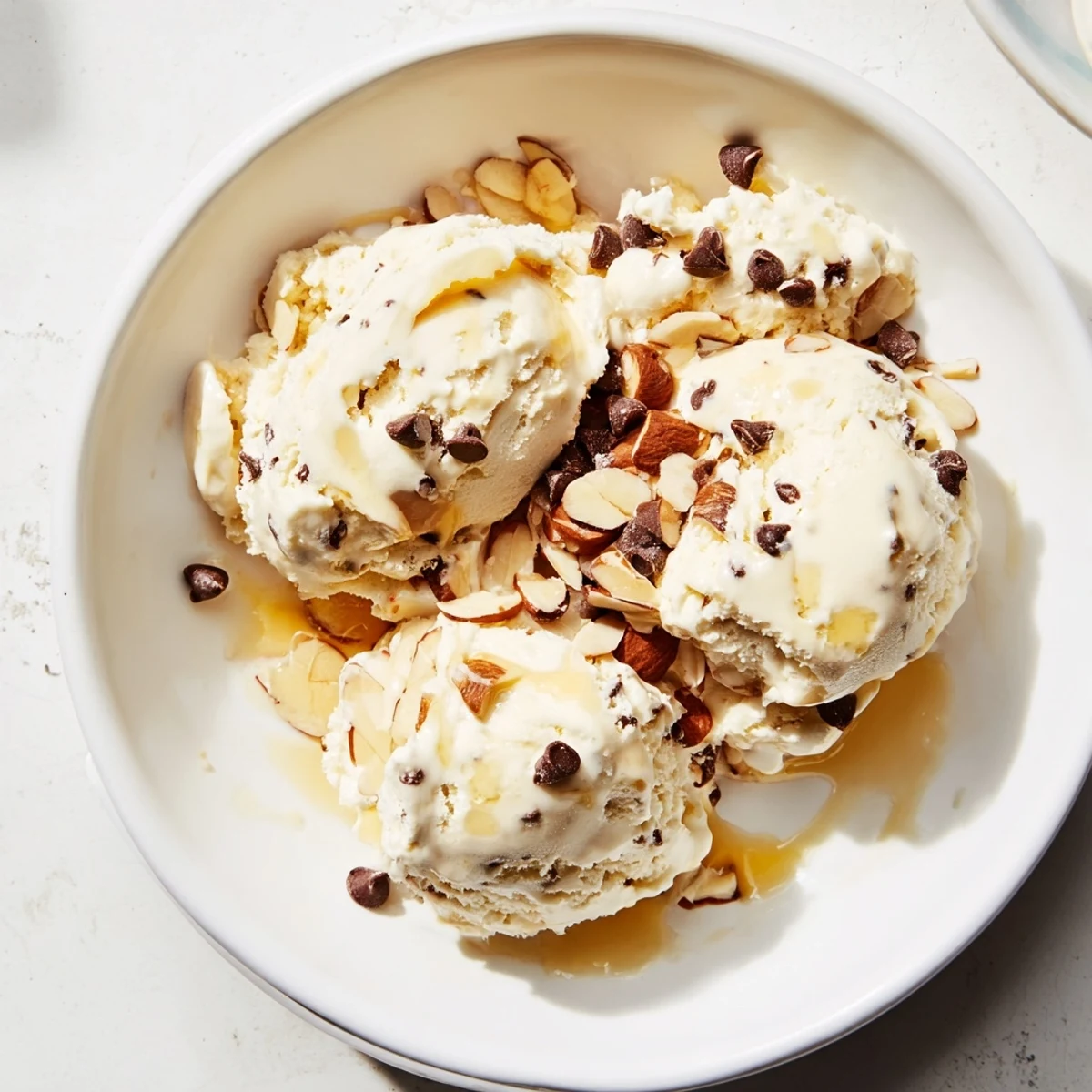 A close-up shot of homemade cottage cheese ice cream, swirled with chocolate chips.