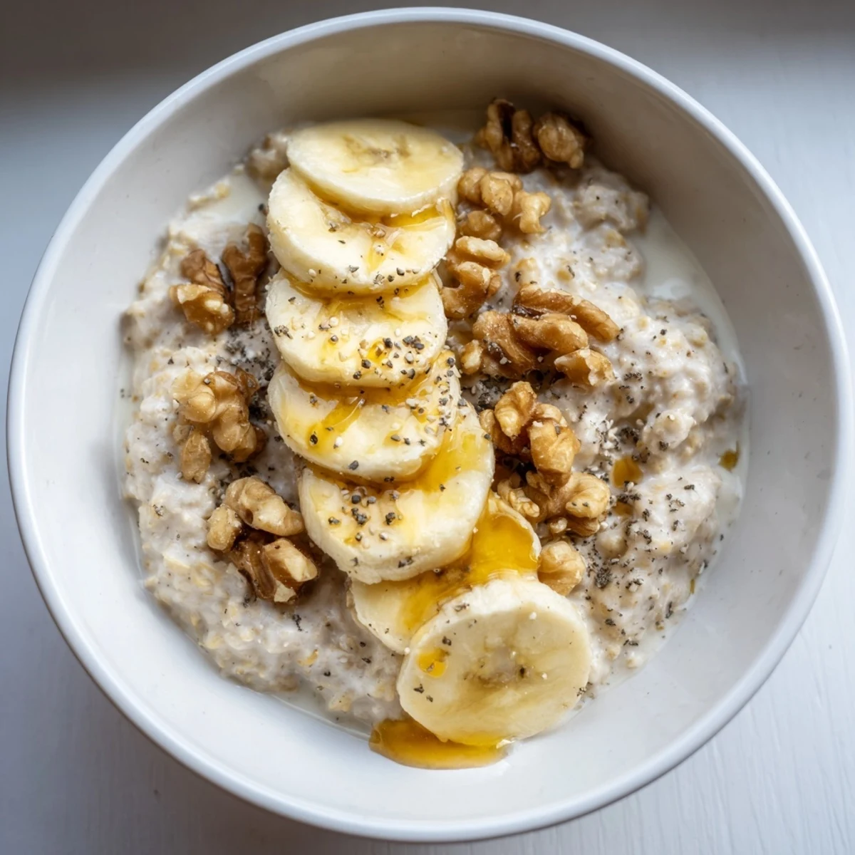 Creamy microwave banana oats, topped with fresh banana slices, ready for a warm breakfast moment.