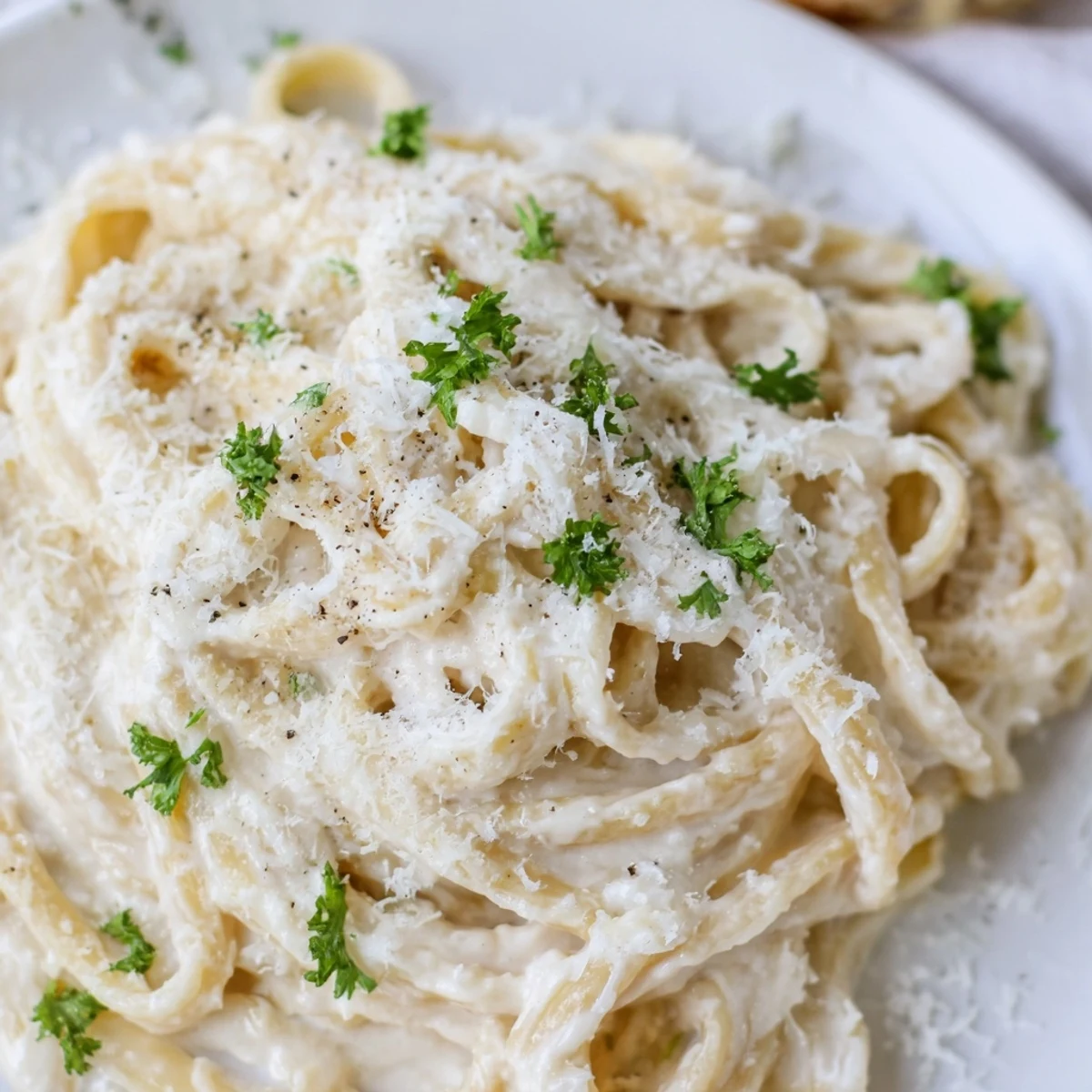 Smooth, blended cottage cheese Alfredo sauce bubbling gently in a saucepan, Italian flavors.