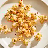 A close-up of buttery, glistening Hot Honey Butter Popcorn, savory and sweet, ready to enjoy.