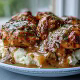 Tender Slow Cooker Honey Mustard Chicken drizzled with rich sauce alongside creamy mashed potatoes and herbs