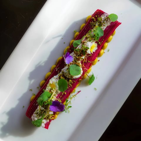 A minimalist Modernist Stripe appetizer with vibrant purées, garnished and ready to serve.