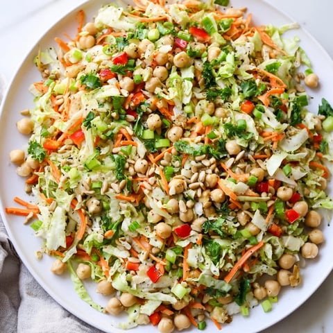 Creamy and colorful fiber-forward chickpea salad, showcasing vibrant vegetables and a bright tahini-lemon dressing.