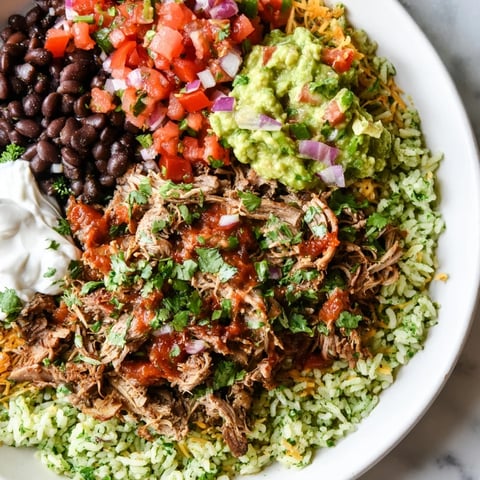 Golden, juicy carnitas alongside vibrant toppings in this Chipotle Burrito Bowl copycat recipe.