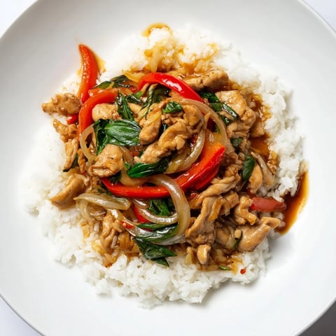 Tender Thai Basil Chicken Bowls with fresh basil and vibrant red bell peppers.