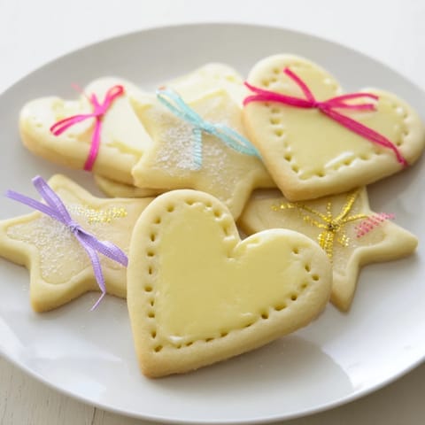 Delicate, heart and star Mignonneries Coeurs et Étoiles cookies, ready to be tied with festive ribbons.