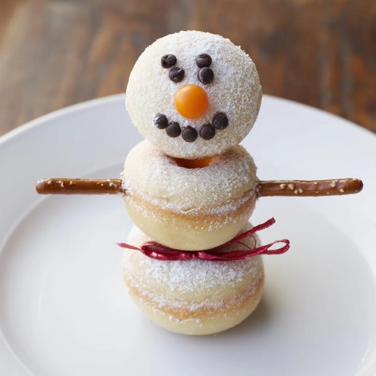 Get a closer look at these fun Mini Donut Snowman stacks, perfectly detailed with candy and fruit leather scarves!