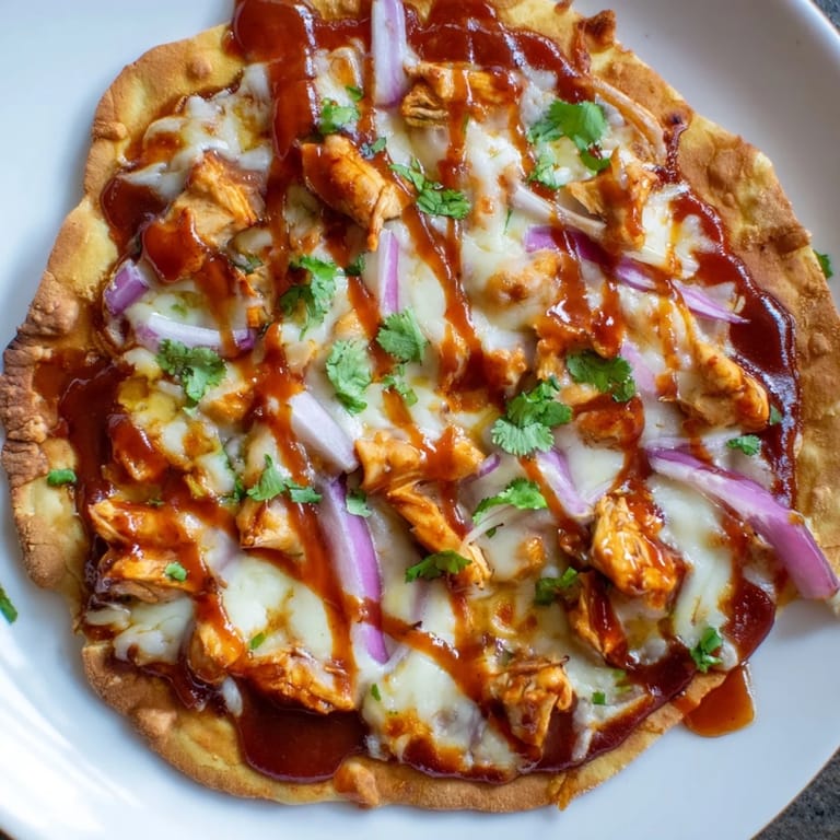 Crispy BBQ Chicken Flatbread, a delicious meal with melted cheese and fresh cilantro.